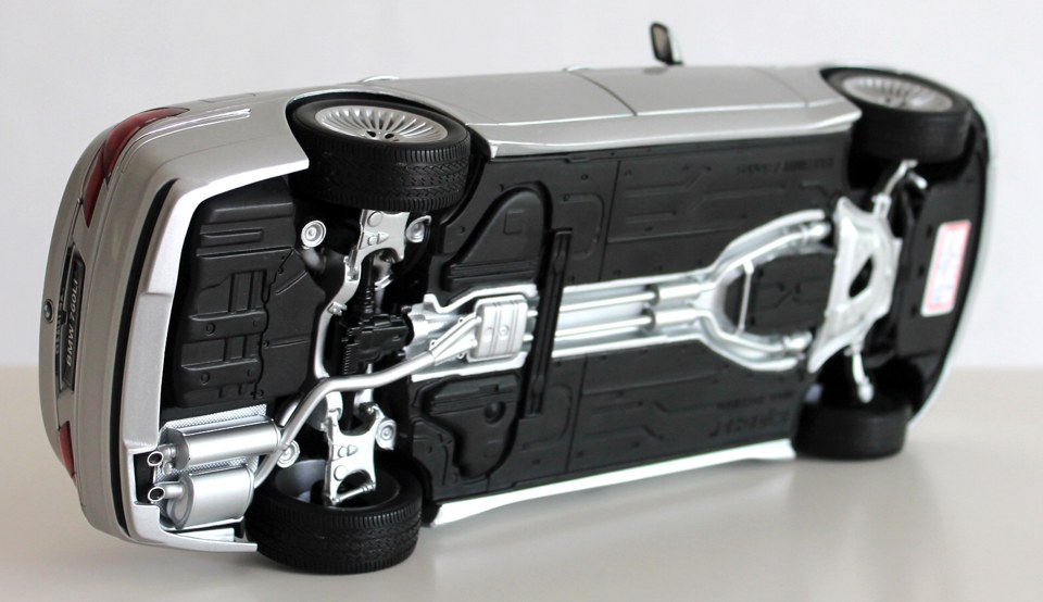 Kyosho BMW 760Li underside showing exhaust molding, four tires and chassis screws