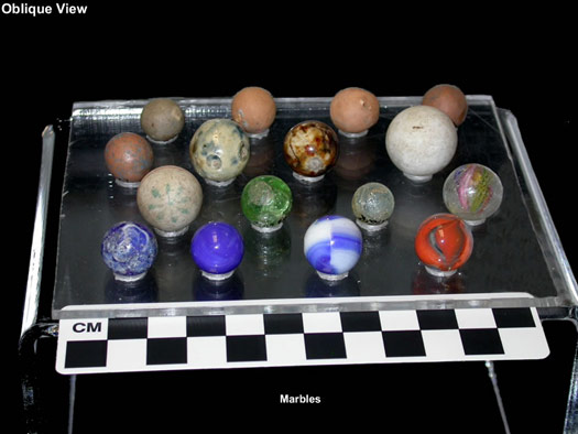 Museum tray of real antique marbles photographed with a scale