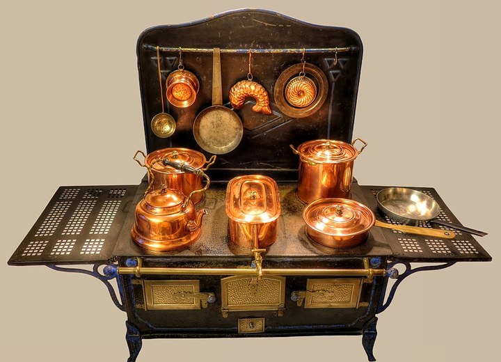 Antique tin doll stove with copper cookware