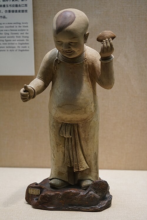Real Shiwan child figure attributed to Chen Weiyan with raised hand and small fingers