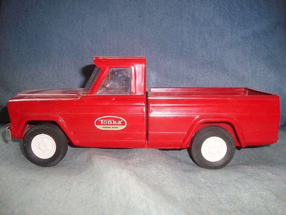Red Tonka pickup with a white oval door decal reading Tonka and Mound, Minn.